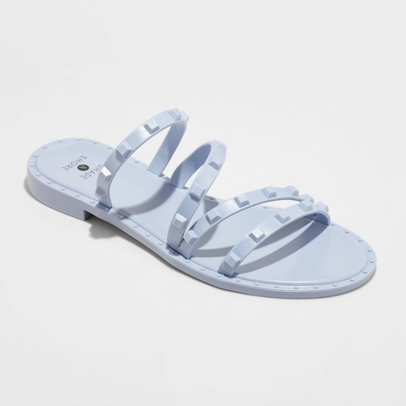 blue strappy jelly sandals with studs on the straps