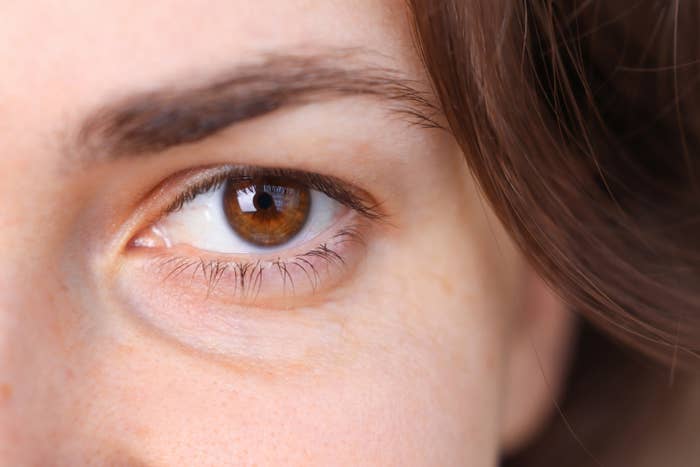Close-up of a woman&#x27;s eyes showing thick, bushy eyebrows