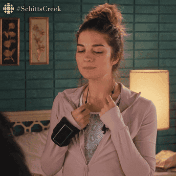 gif of Alexis from Schitt&#x27;s Creek swaying back and forth looking sentimental