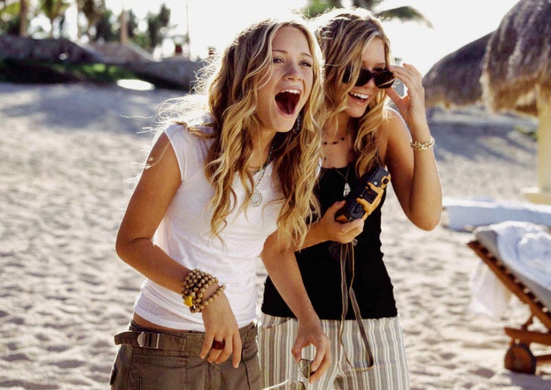 Mary Kate and Ashley laughing on a beach together