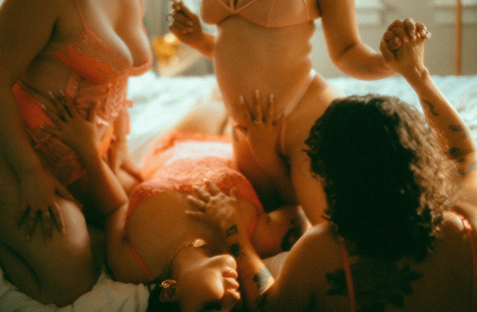 Multiple women being intimate