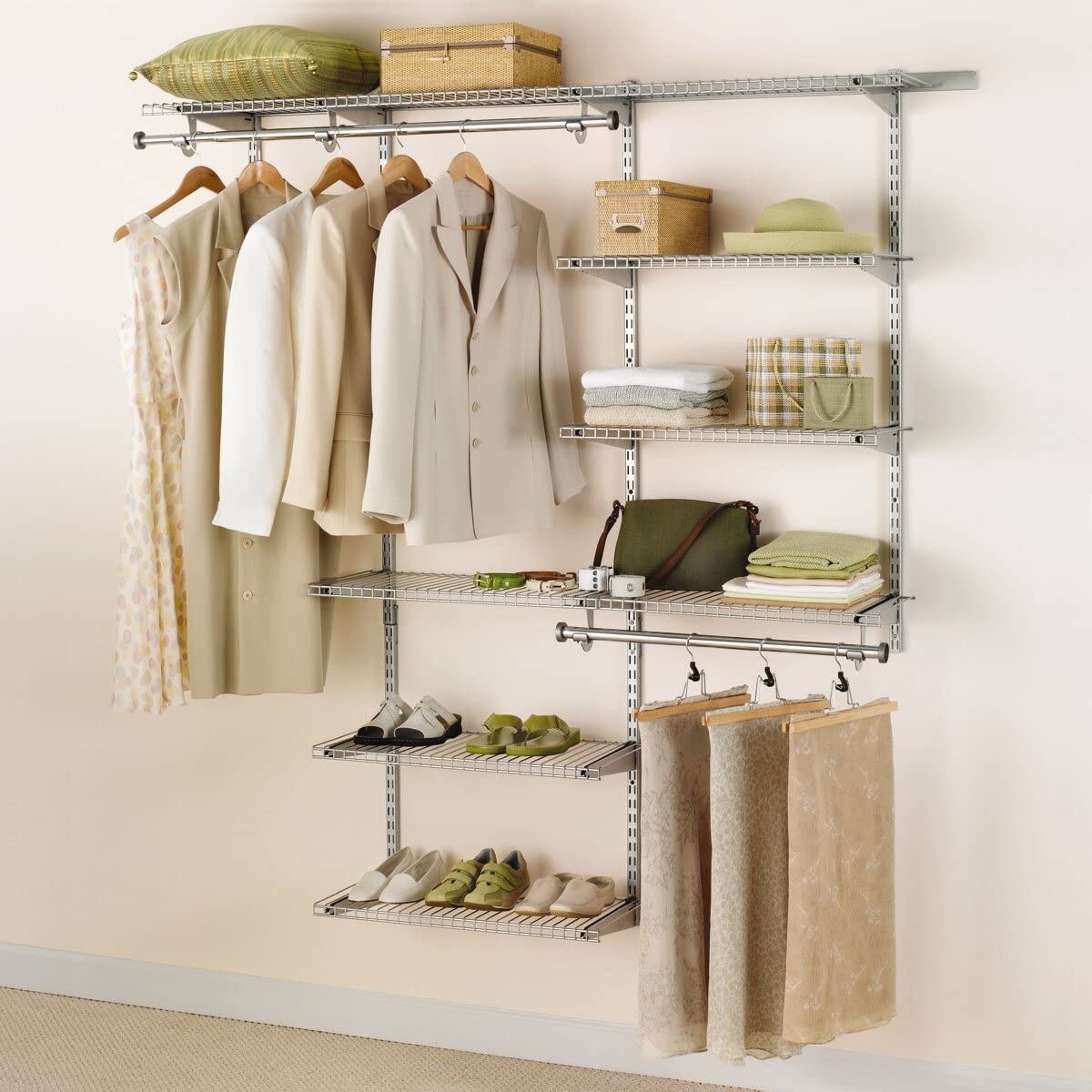 the closet kit with a rack holding hanging clothes and shelves holding accessories
