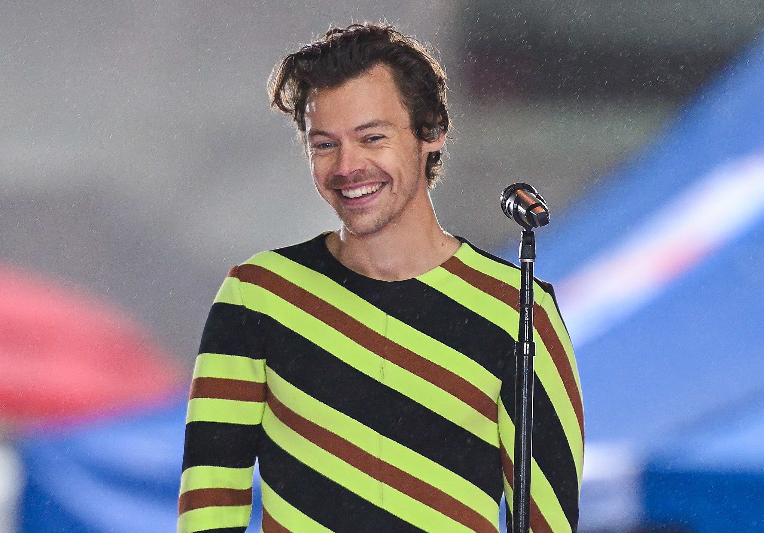 A closeup of Harry on stage smiling