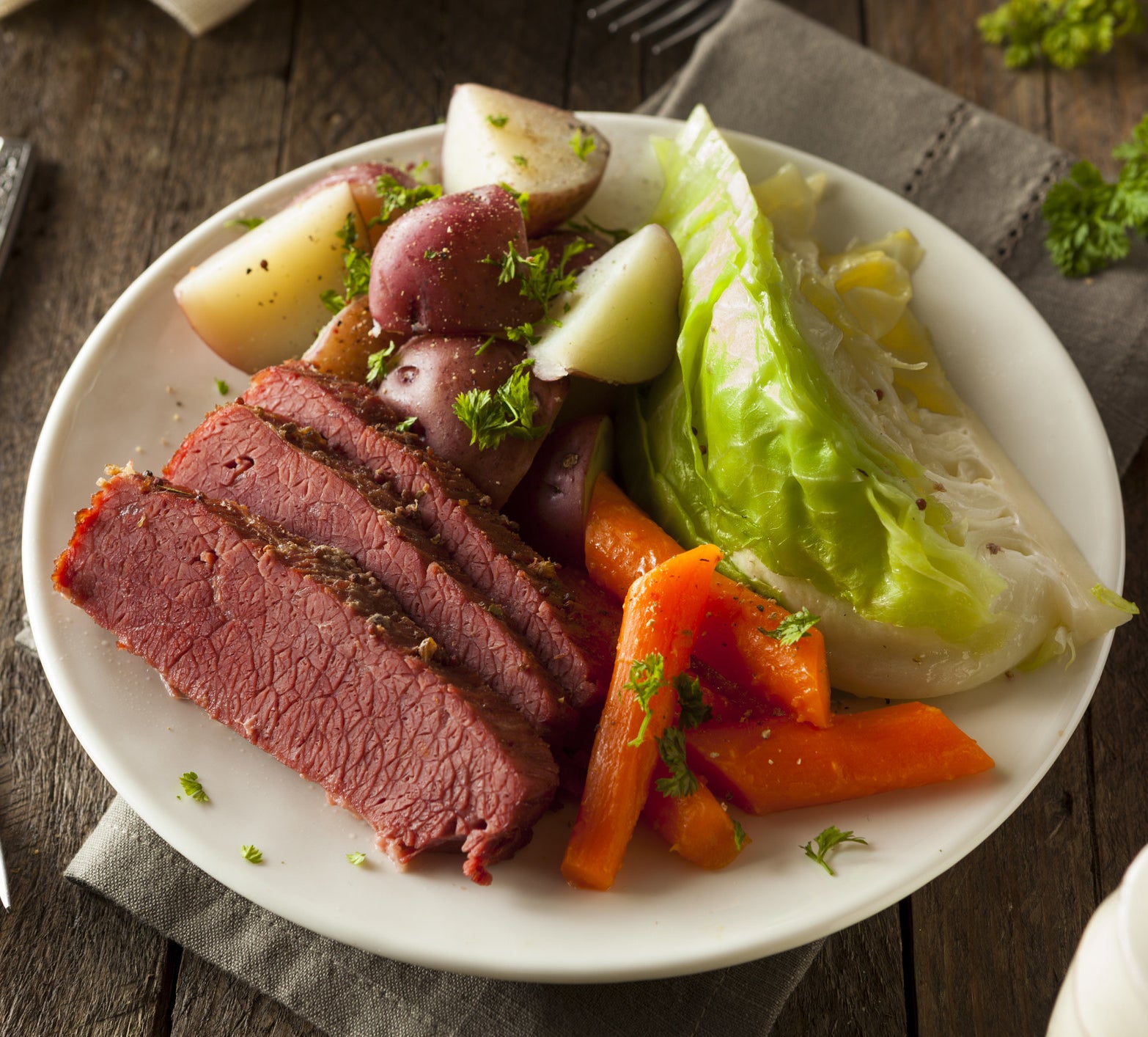 A plate of corned beef, cabbage, and potatoes.