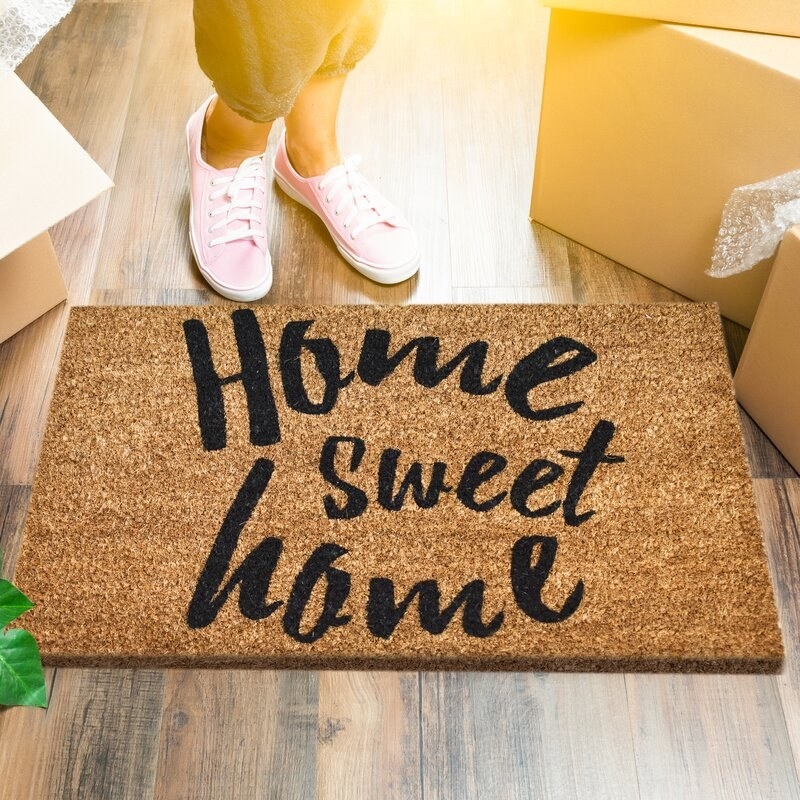 A welcome mat that reads &quot;Home Sweet Home&quot;