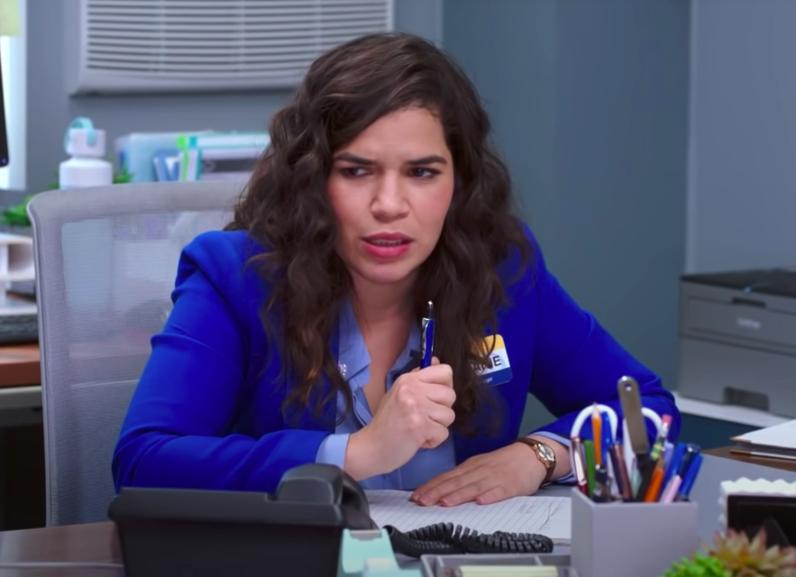 Amy sitting behind a desk with a nametag on