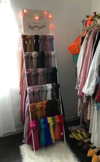 scarves hung on the leaning ladder
