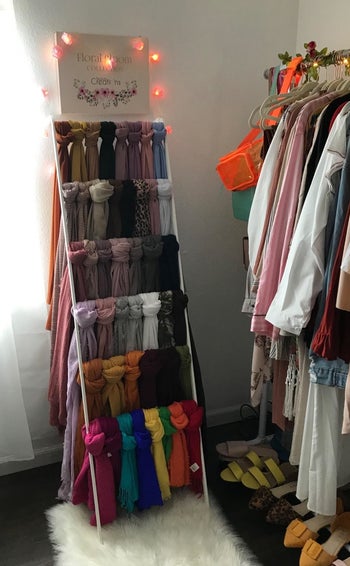 scarves hung on the leaning ladder