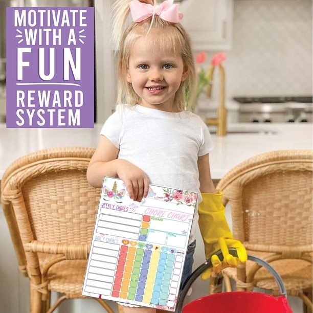 Little girl holding chore chart