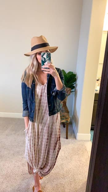 a reviewer wearing the dress with a denim jacket