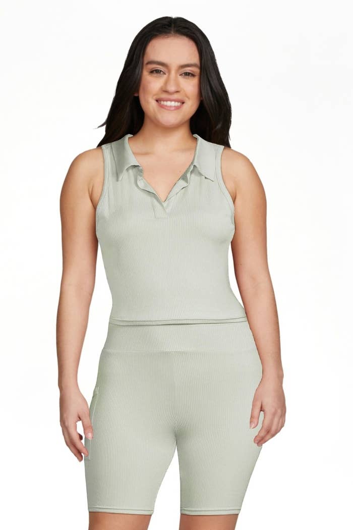 a model wearing the ribbed mint colored sleeveless top and biker short set