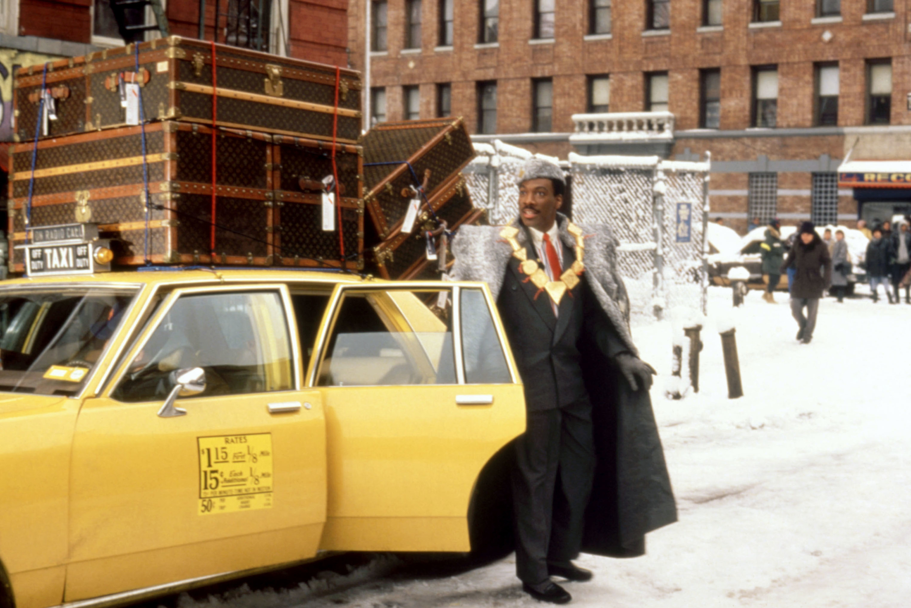 A man in royal garb exits a taxi cab