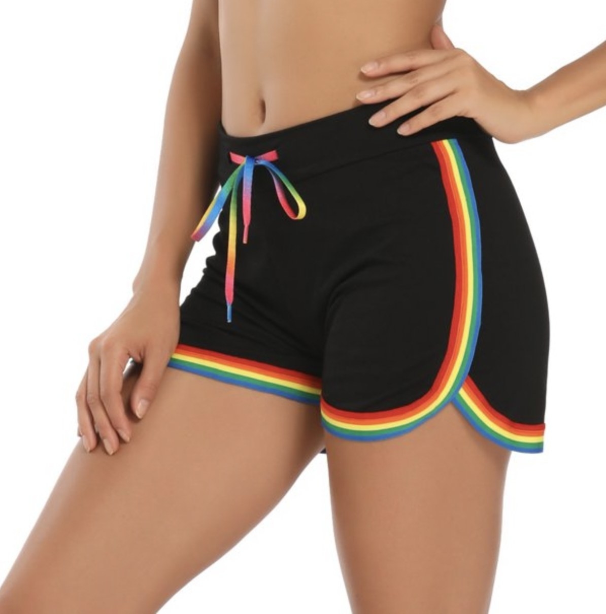 A person wearing black shorts with striped rainbow detailing at the trim