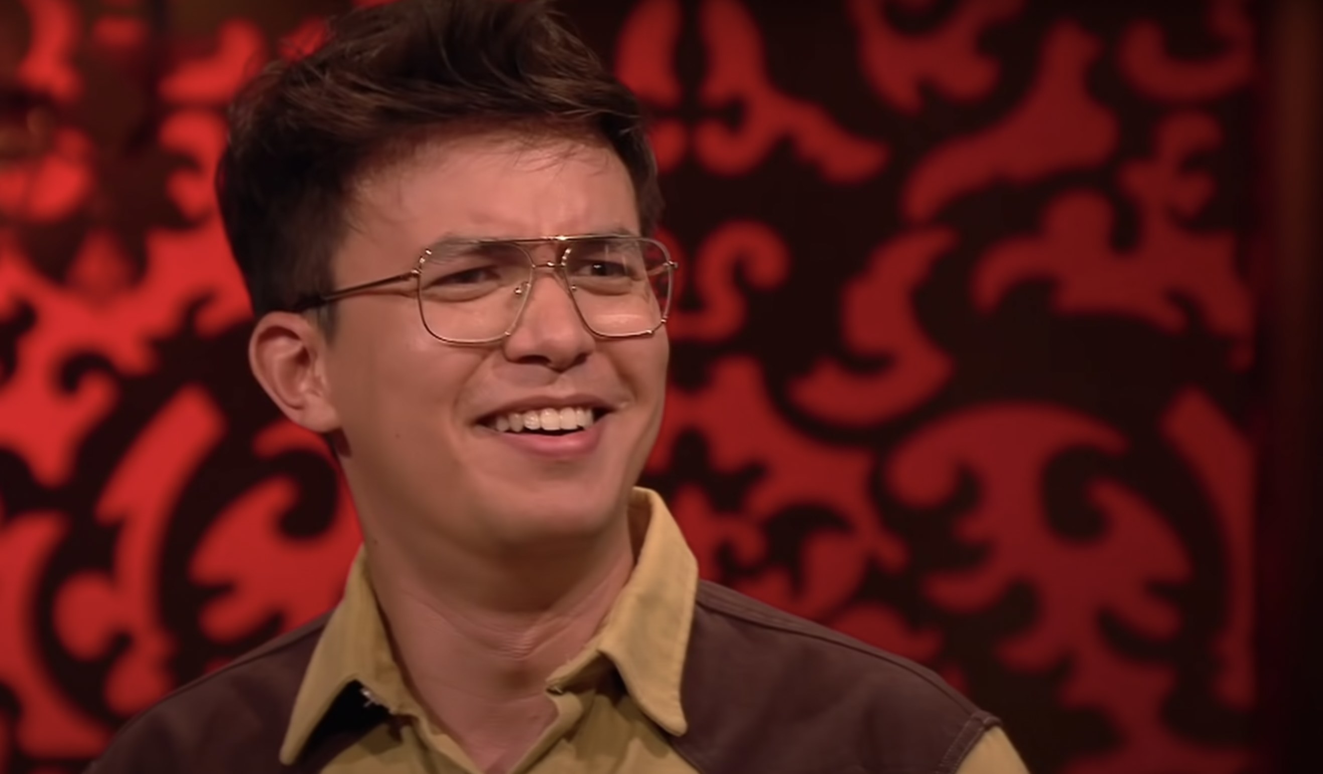 Phil Wang on Taskmaster smiling and looking confused