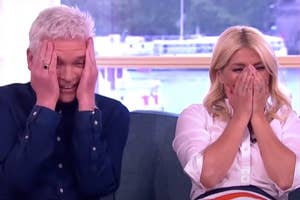 A man and a woman laughing and cringing