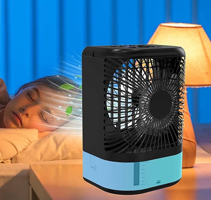 The air conditioner on a bedside table beside somebody is sleeping