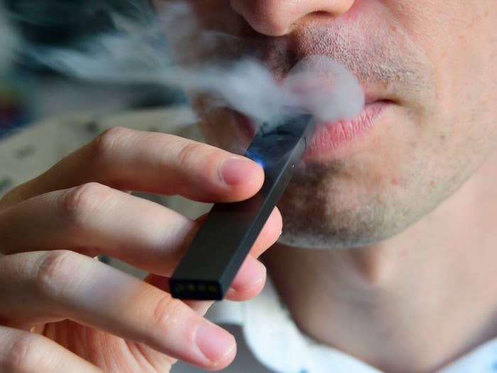 A person using a Juul e-cigarette