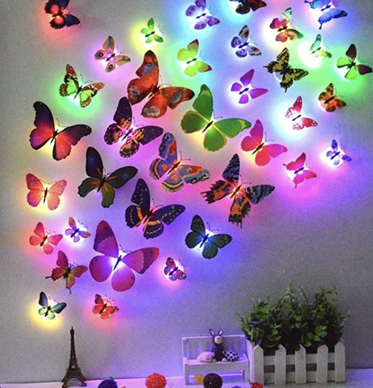 a bunch of the butterfly stickers lit up on the wall