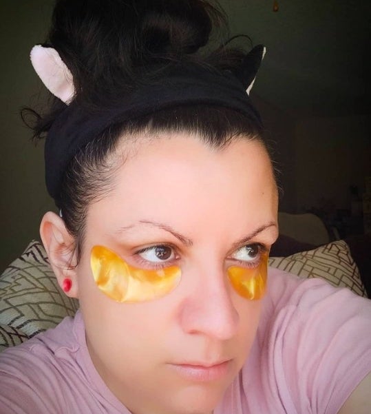 Reviewer wearing gold under eye masks