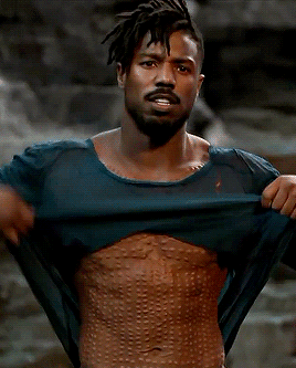 Killmonger takes off his shirt to reveal his scars