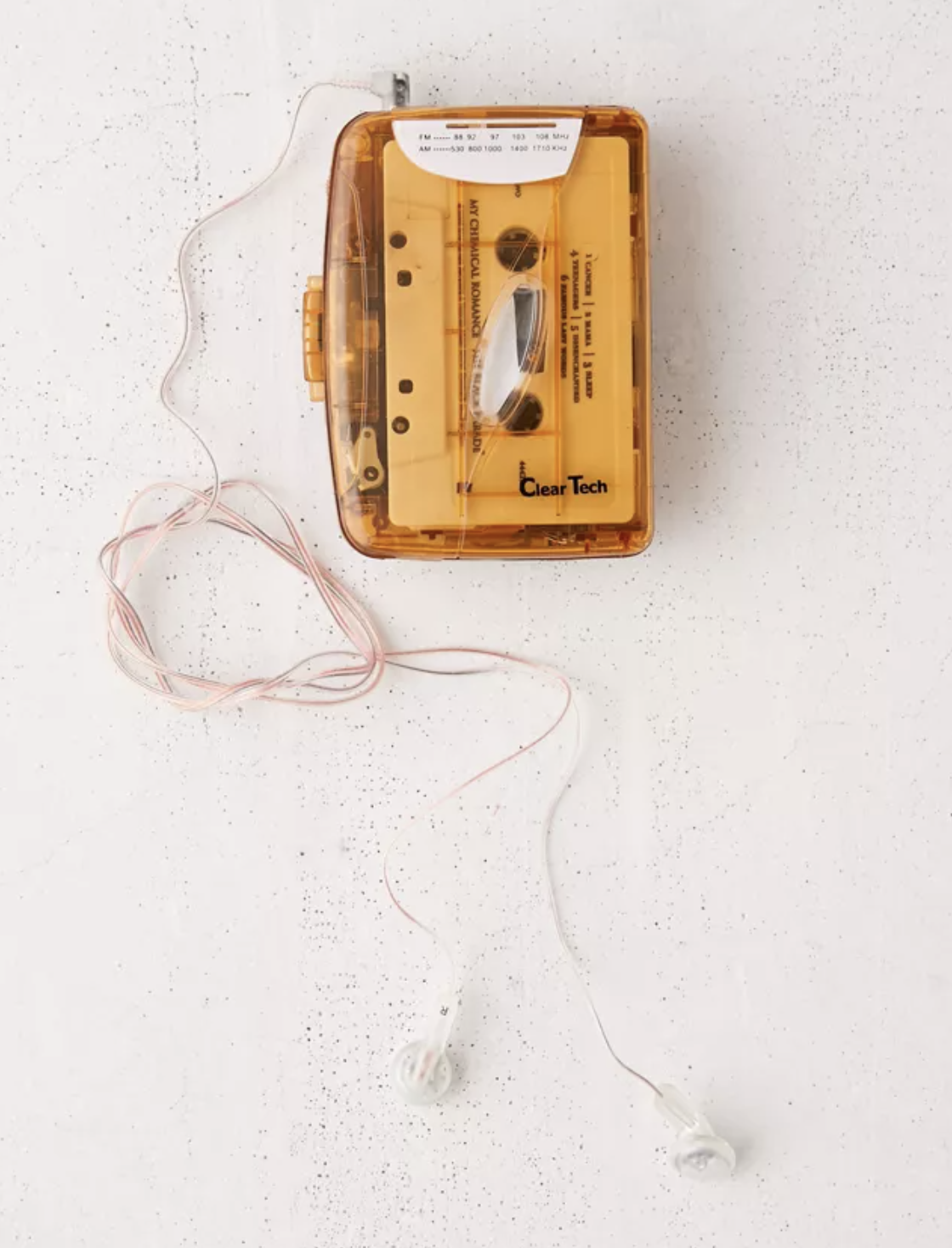 A cassette player with earbuds on a plain background