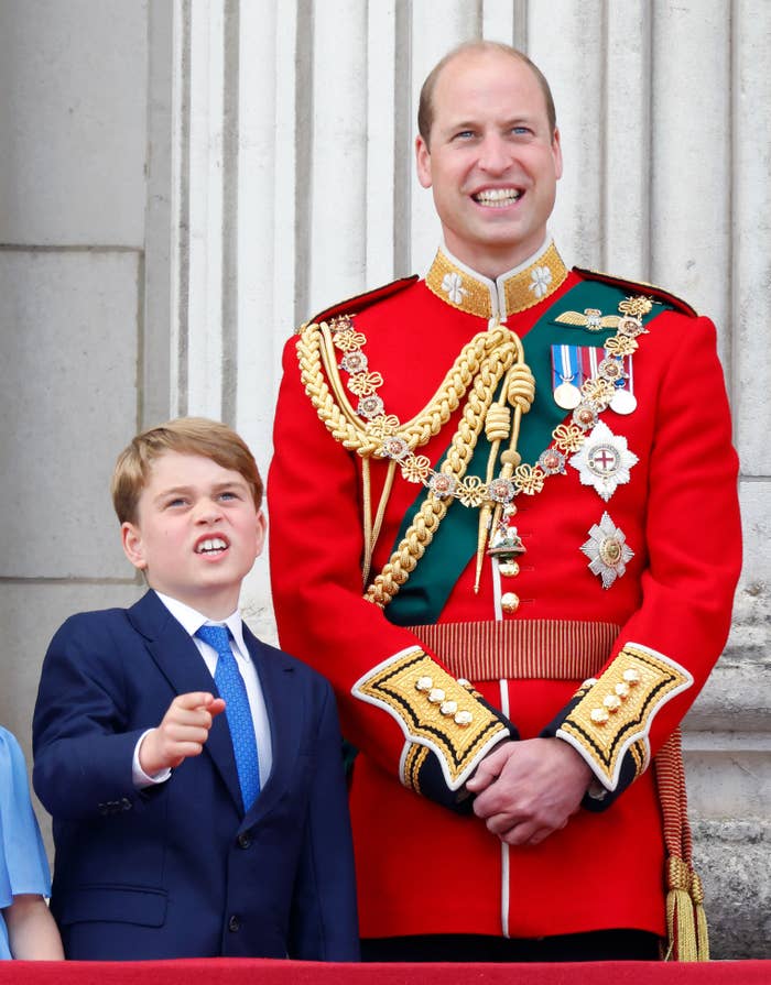 William in royal regalia with his son George in a suit