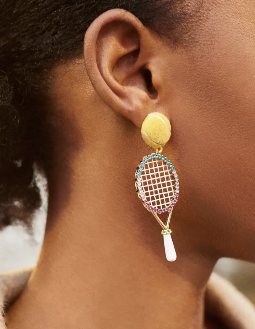 a close up of the tennis racket shaped earrings in someone&#x27;s ears