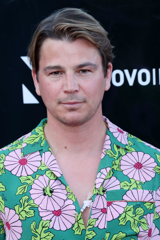 Close-up of Josh in the flowery shirt, unbuttoned at the top