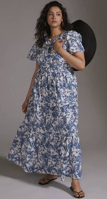 model wearing a blue and white printed maxi dress