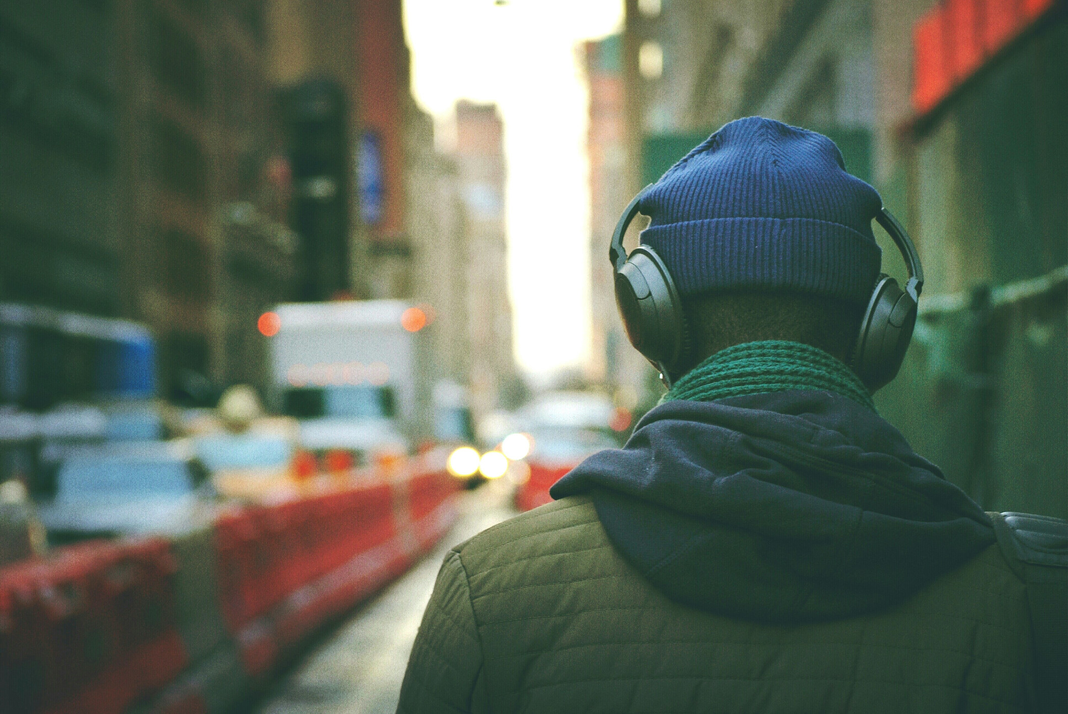 A rear view of a man with headphones on