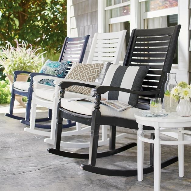 three rocking chairs on a porch in black, white, and blue