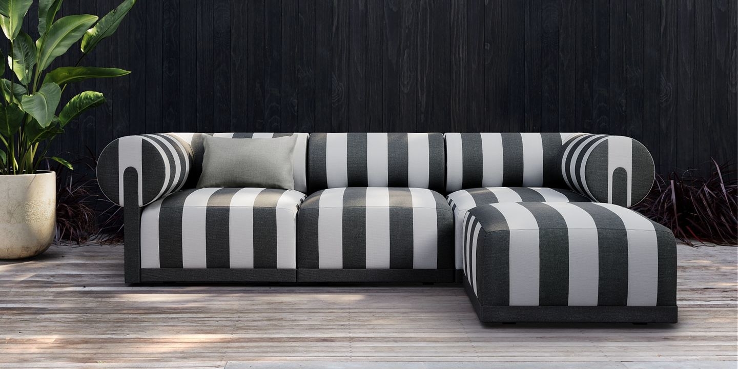 a black and white striped sofa and ottoman outside