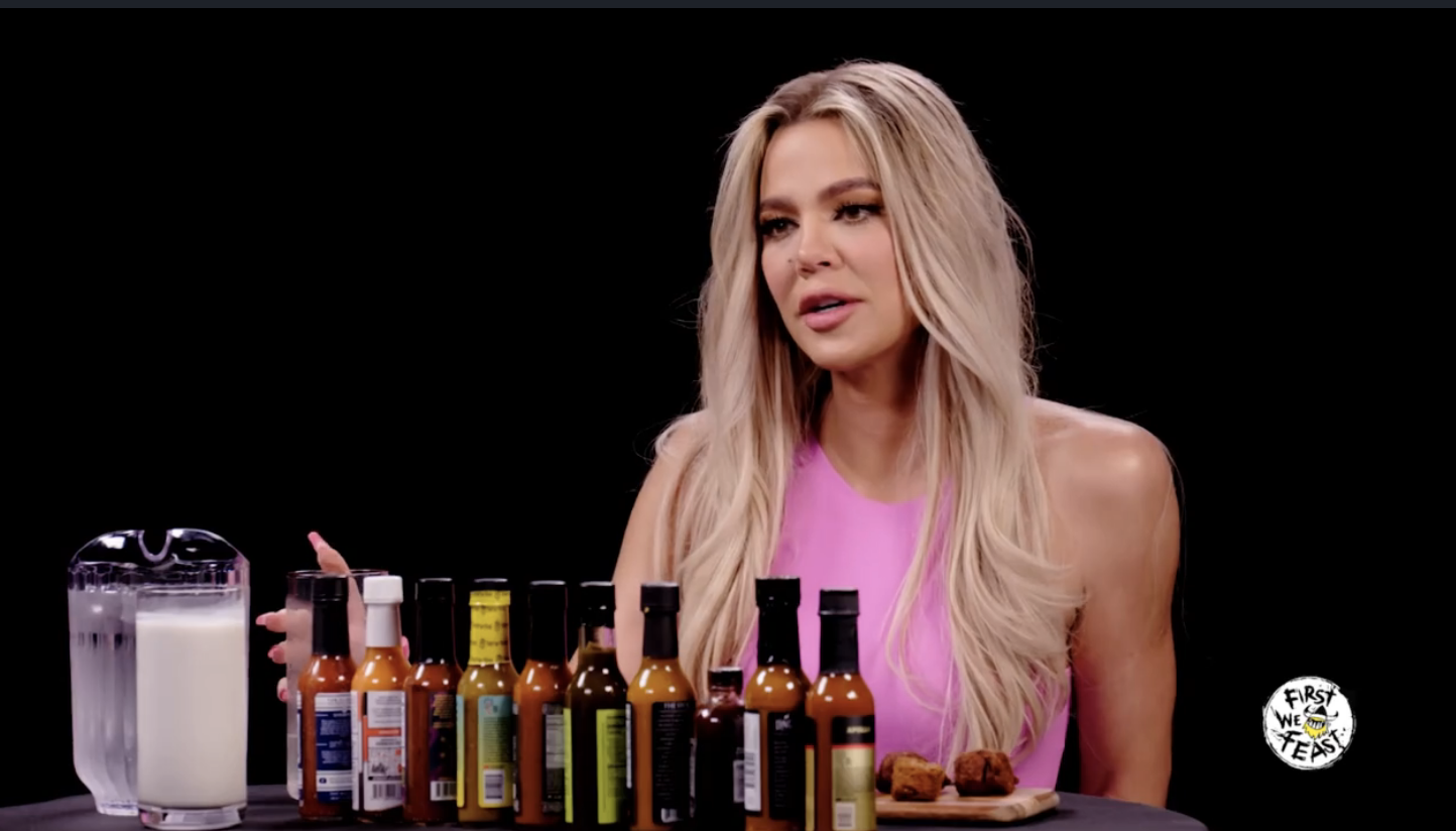 Khloe sitting in front of the sauces looking fresh with perfect make up again