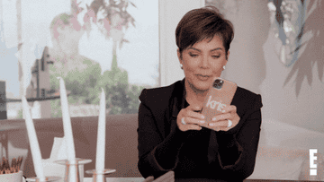 Kris Jenner on her cellphone with a Kris sticker on it