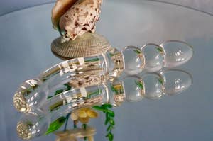 The glass toy lying on a mirrored table
