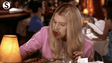 woman eating aggressively in a scene from white chicks