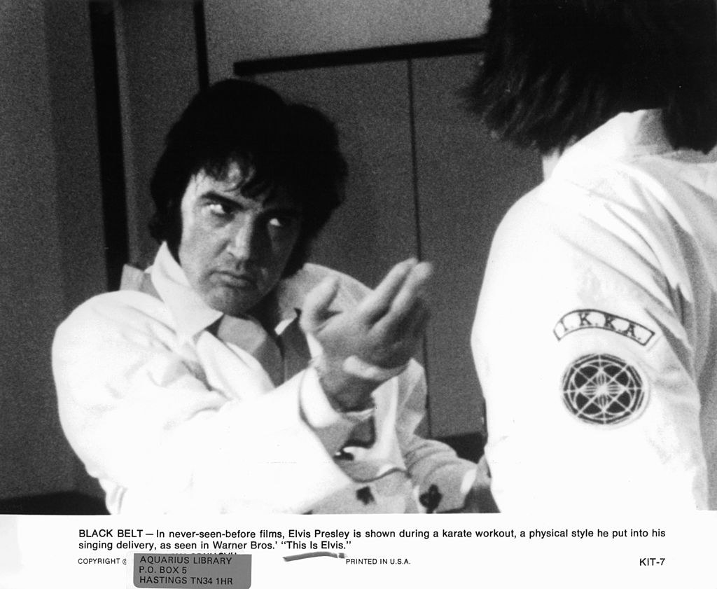 Elvis doing karate training, with a caption that says he used the physical style from karate in his singing delivery