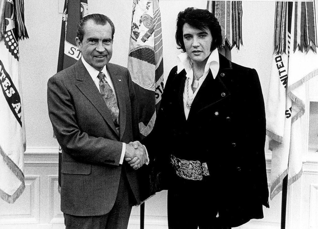 Elvis and president Nixon shaking hands as they pose for a picture together