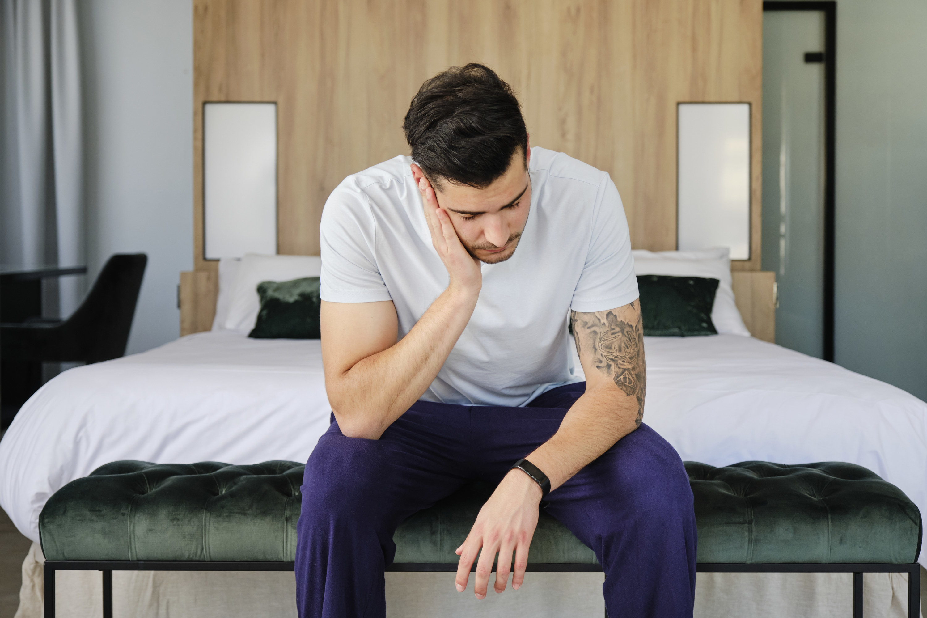 Man slumps into his hand looking stressed