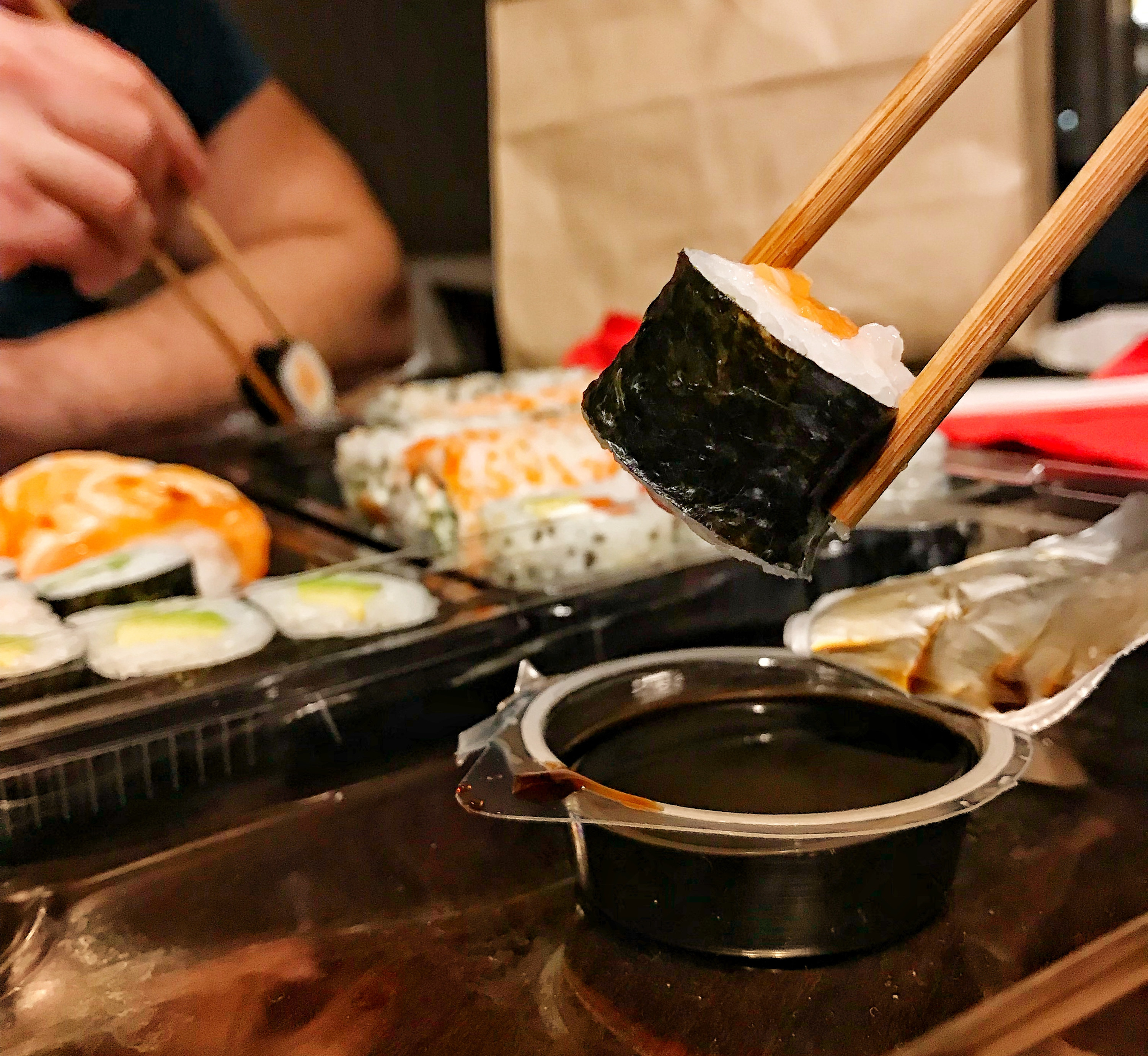 Close-up of two friends eating sushi