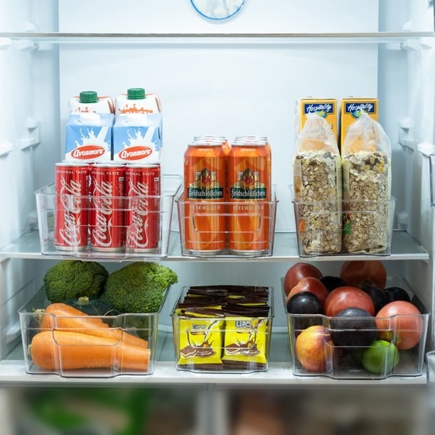 A well-organized refrigerator stocked with various beverages, vegetables, and boxed foods
