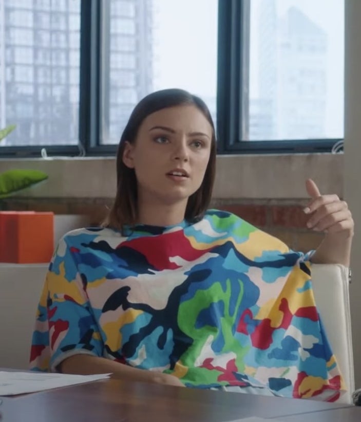 Aviva Mongillo in a colorful shirt sitting in a chair.