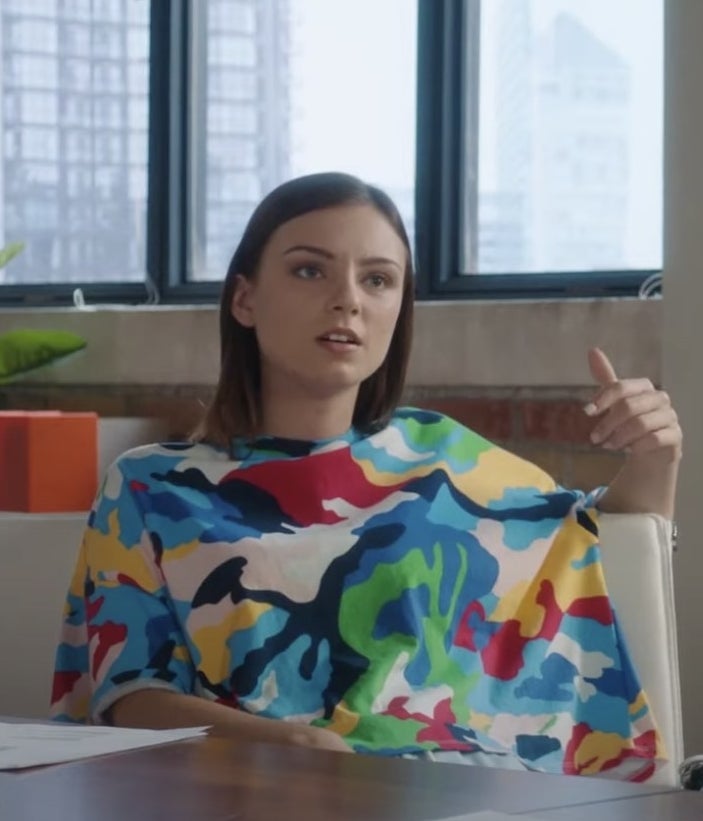 Aviva Mongillo in a colorful shirt sitting in a chair.