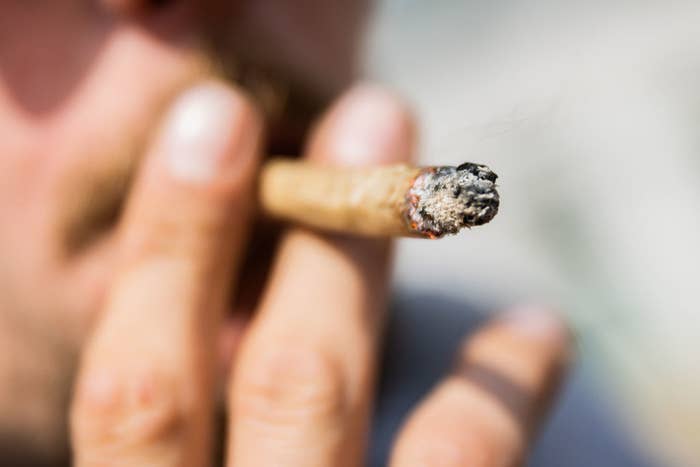 A man smokes a joint of medical cannabis