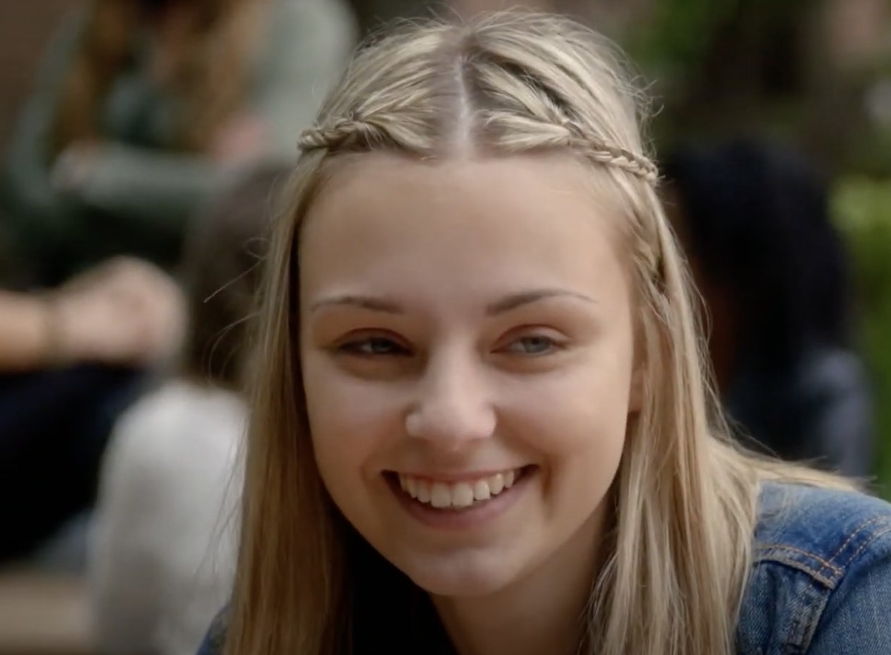 Aviva Mongillo with blonde hair smiling off-camera.