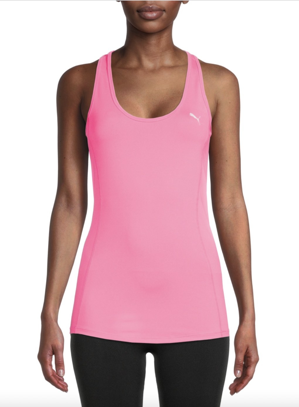 A person wearing a pink tank top with black leggings