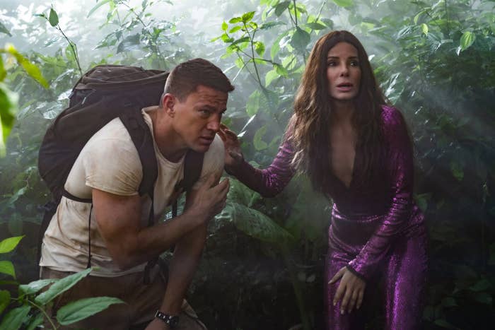 Sandra Bullock leans on channing tatum in a jungle setting in the movie The Lost City