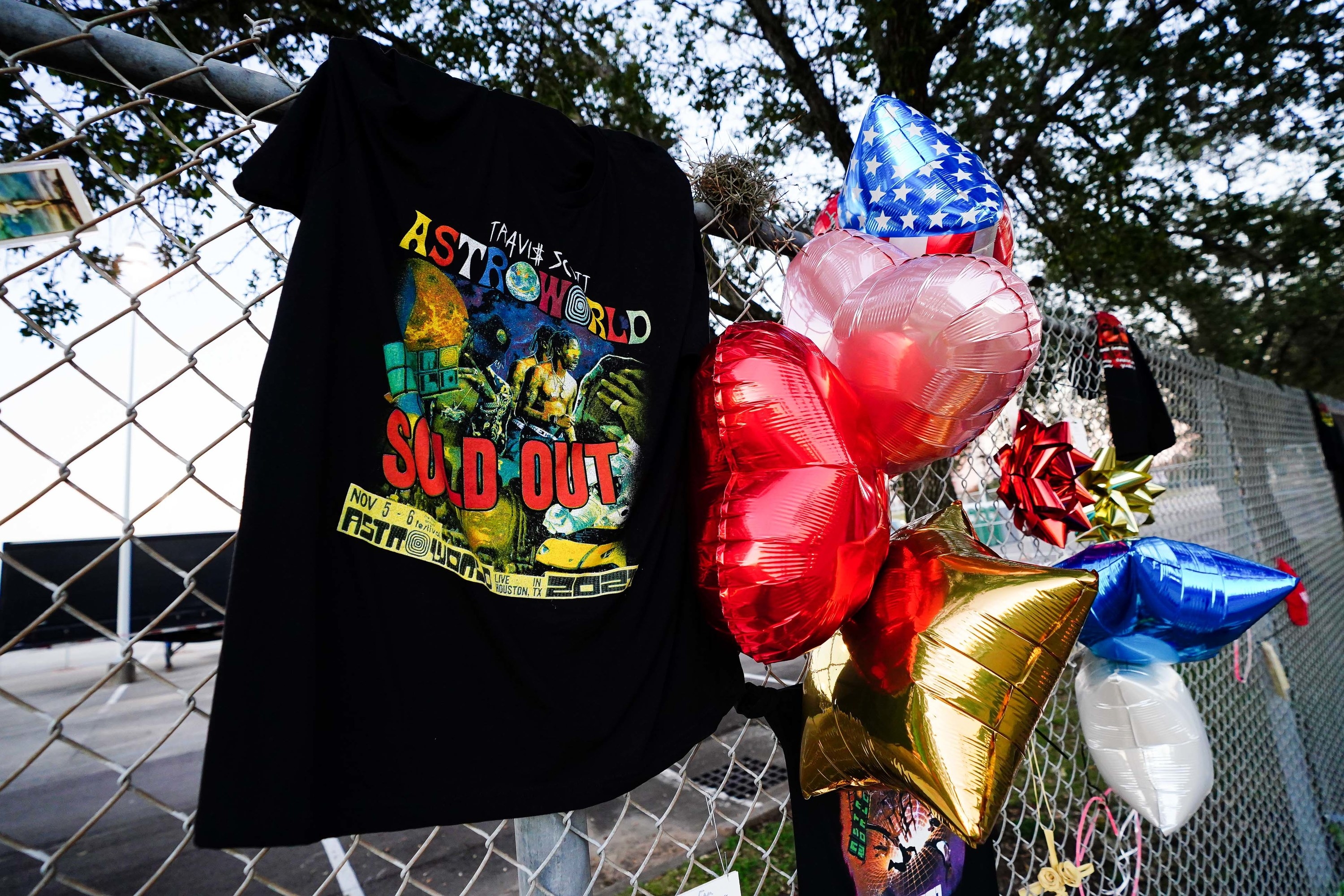 A T-shirt and balloons are placed at a memorial outside of the canceled Astroworld festival at NRG Park on November 7, 2021, in Houston