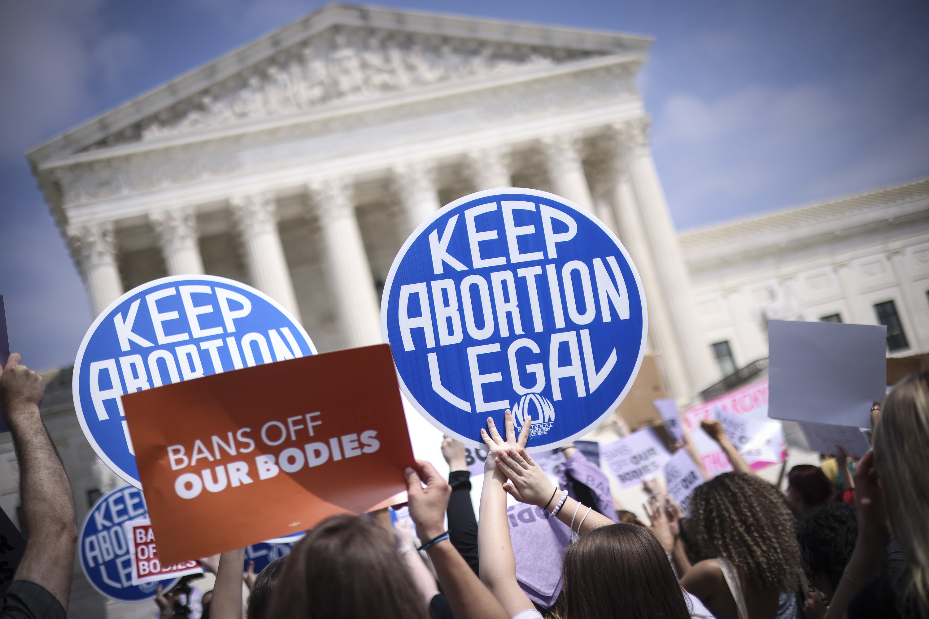 Protesters holding keep abortion legal signs