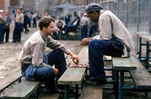 Tim Robbins as Andy Dufresne and Morgan Freeman as Red playing checkers in &quot;The Shawshank Redemption&quot;